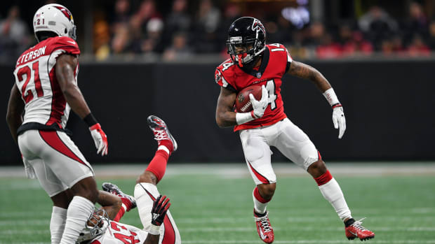 Dec 16, 2018; Atlanta, GA, USA; Atlanta Falcons wide receiver Justin Hardy (14) runs past Arizona Cardinals outside linebacker Haason Reddick (43) during the first half at Mercedes-Benz Stadium. Mandatory Credit: Dale Zanine-USA TODAY Sports  
